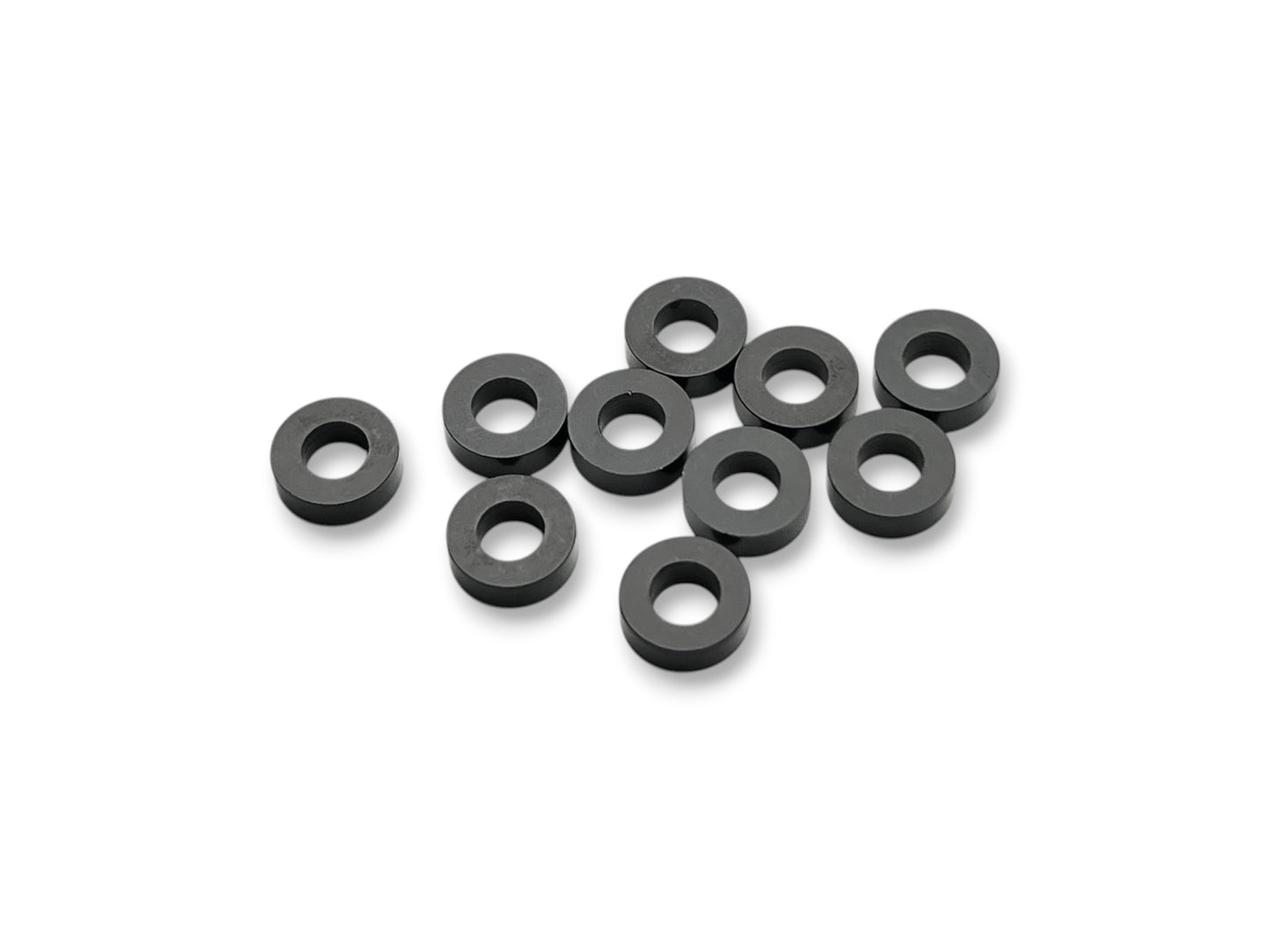 Sortafast 3 × 6 × 2.0 mm aluminum shims in black anodized finish. Precision-machined for suspension, roll center, and setup adjustments. Includes 10 pieces.