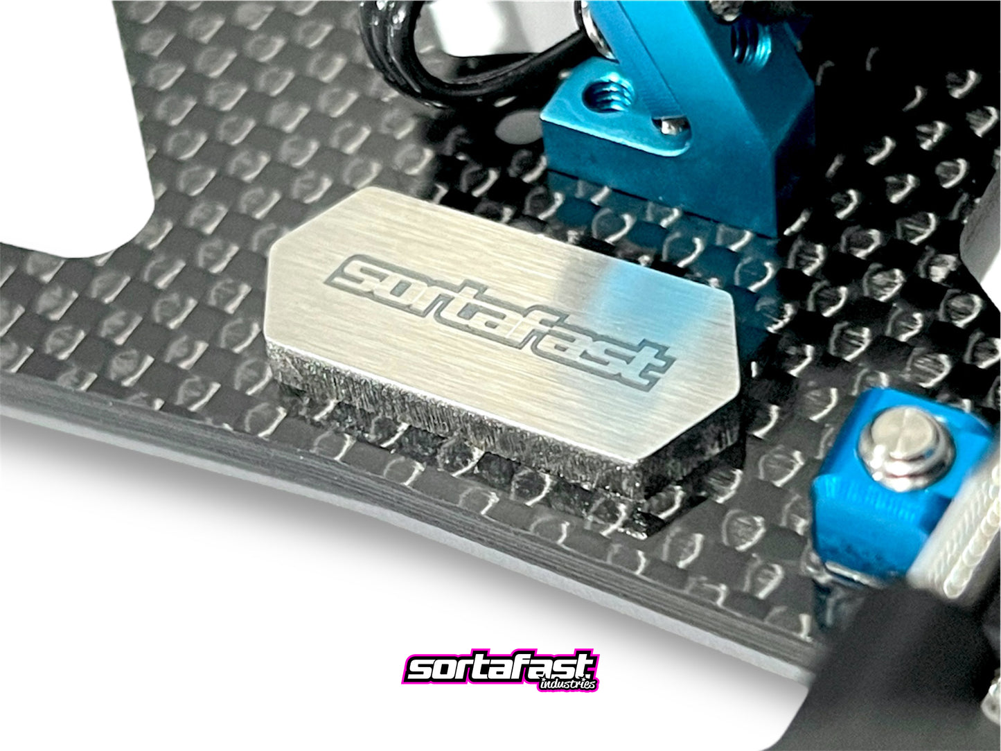 Sortafast Stainless Steel Chassis Weight – 5.5g precision-cut 3mm stainless steel weight for RC car balance tuning. Shown installed close up on RC car chassis.