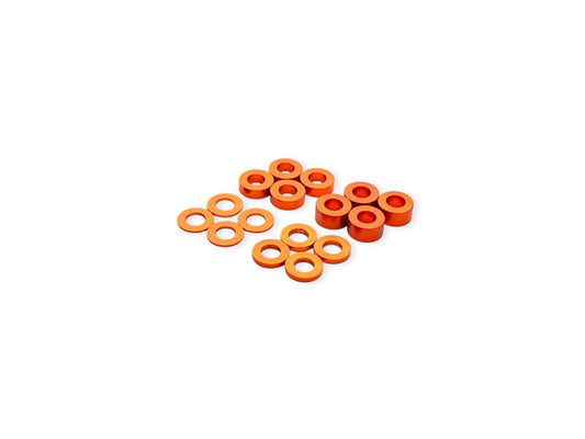 Sortafast 3x6mm aluminum shims in orange anodized finish, assorted thicknesses (0.5mm, 1mm, 2mm, 3mm), displayed on a white background – 16-piece pack.