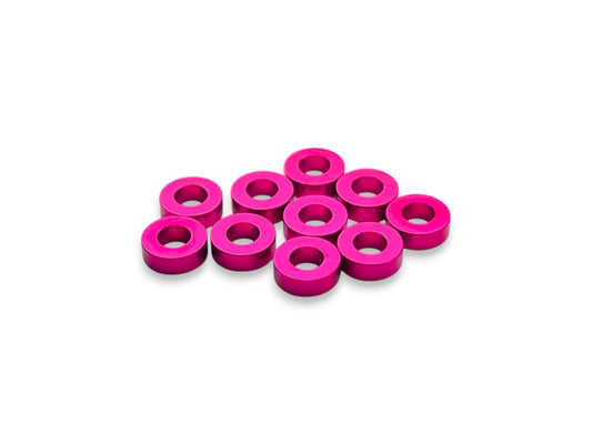 Sortafast 3 × 6 × 2.0 mm aluminum shims in hot pink anodized finish. Precision-machined for suspension, roll center, and setup adjustments. Includes 10 pieces.