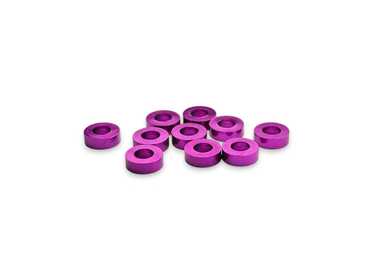 Sortafast 3 × 6 × 2.0 mm aluminum shims in purple anodized finish. Precision-machined for suspension, roll center, and setup adjustments. Includes 10 pieces.
