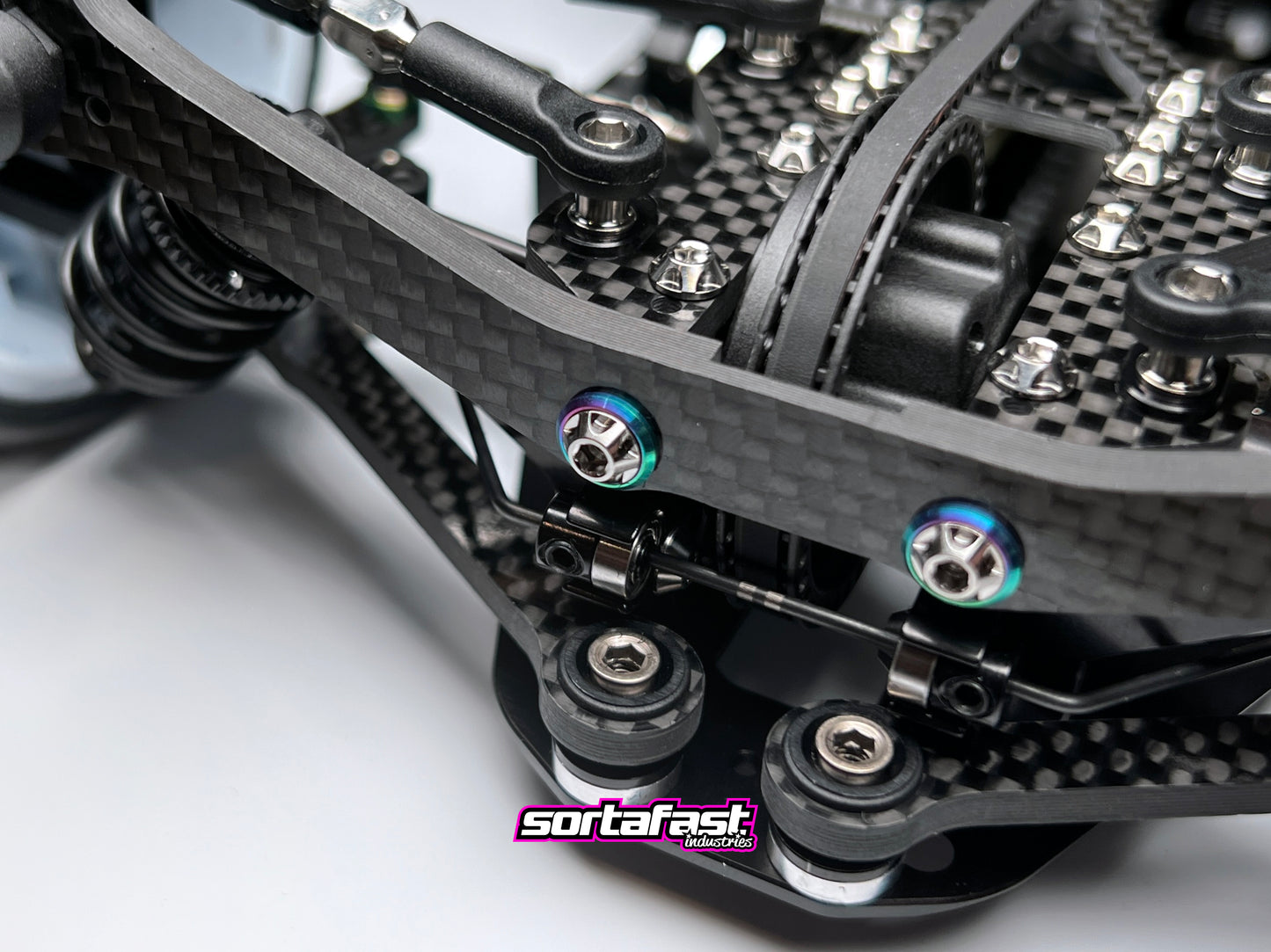 Sortafast M3 titanium button washers – Grade 5 precision washers with oil slick finish designed for Sortafast button head screws, offering increased footprint, durability, and premium visual style.