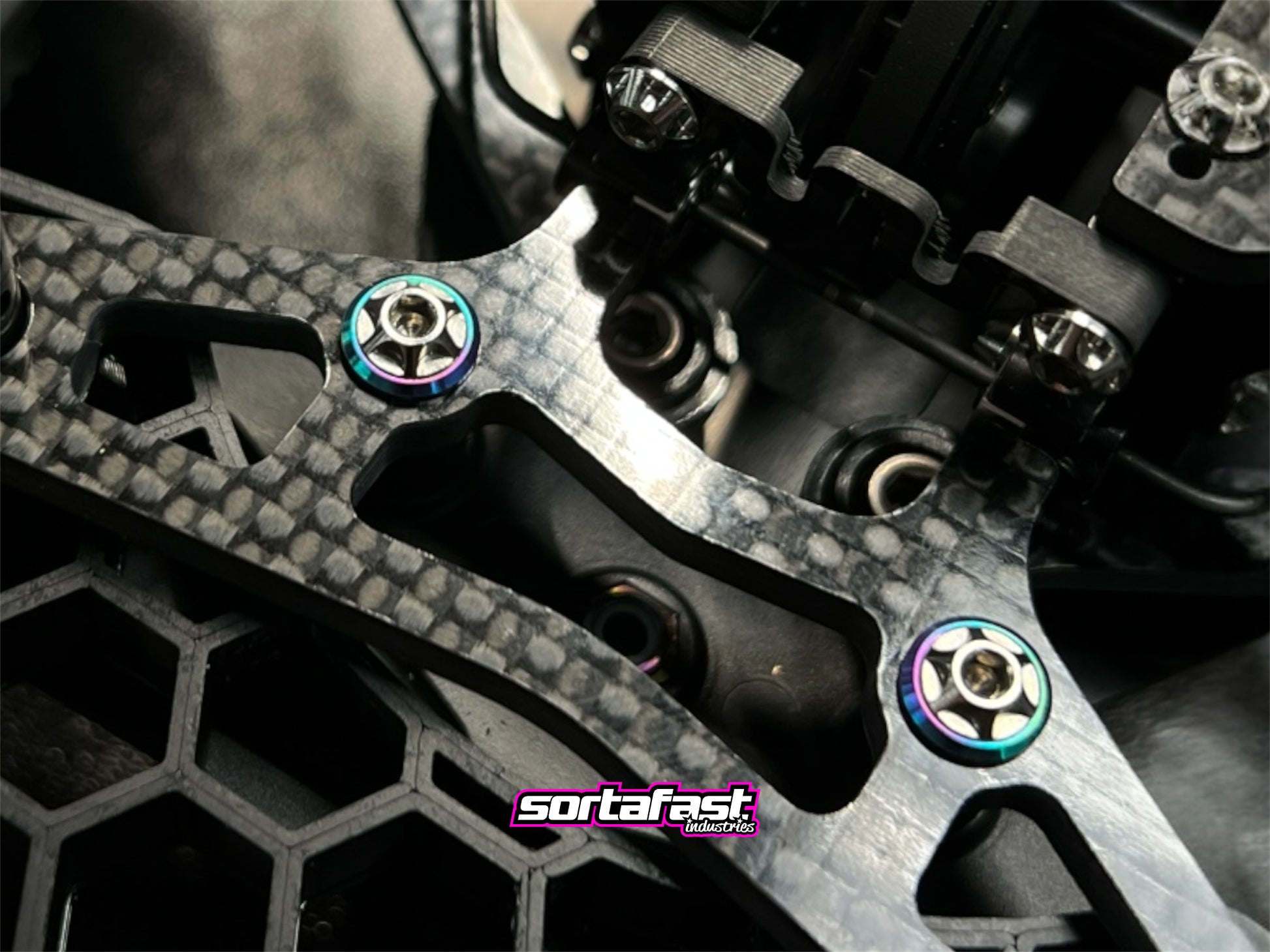 Sortafast M3 titanium button washers – Grade 5 precision washers with oil slick finish designed for Sortafast button head screws, offering increased footprint, durability, and premium visual style.