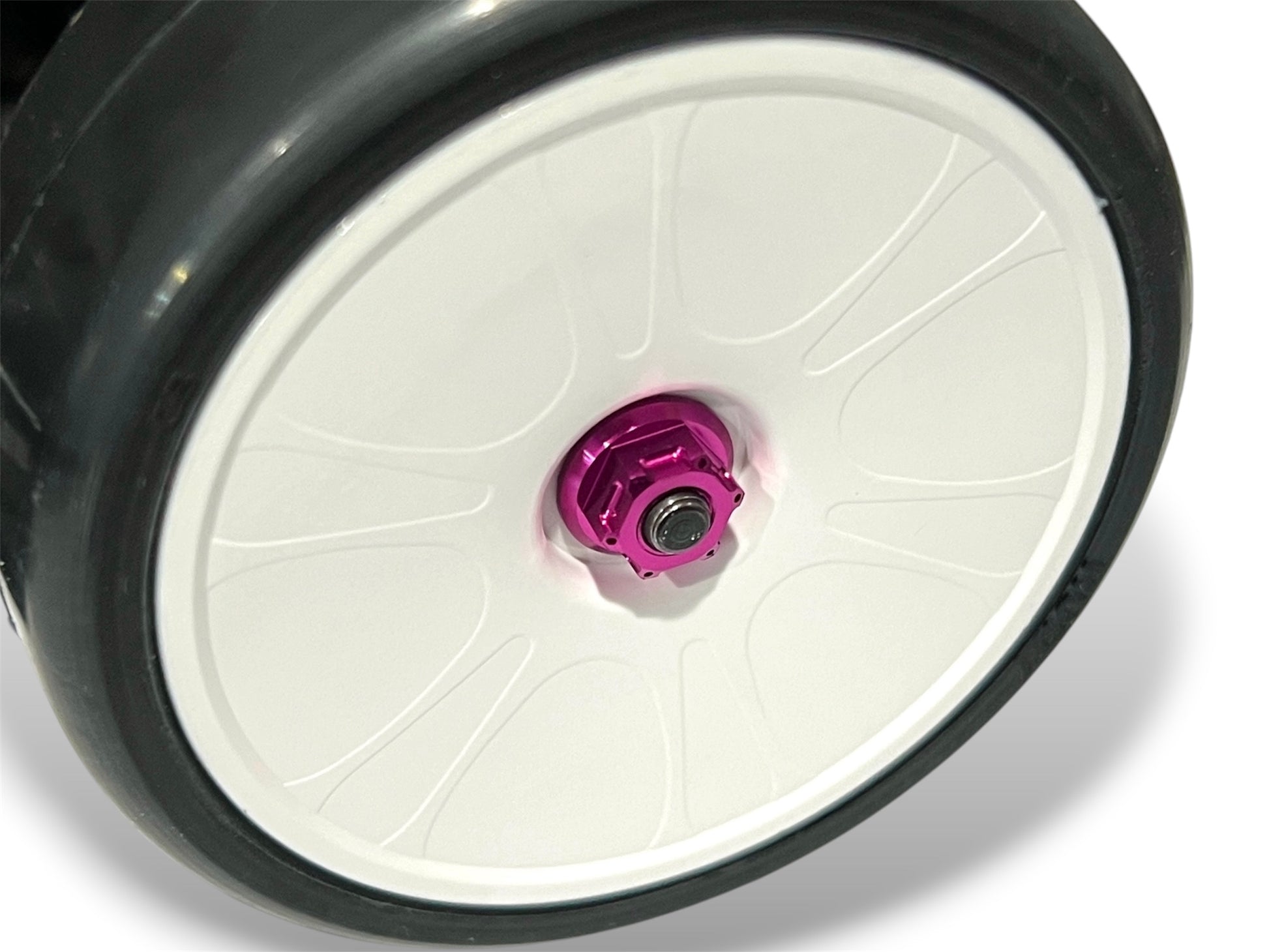 Sortafast M4 Hexcix flanged aluminum RC wheel nuts in purple shown installed on a RC car chassis and wheel. 