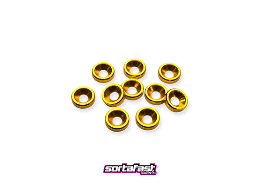 Close-up of 10 gold anodized aluminum countersink washers for M3 screws, arranged on a white background with Sortafast logo for branding