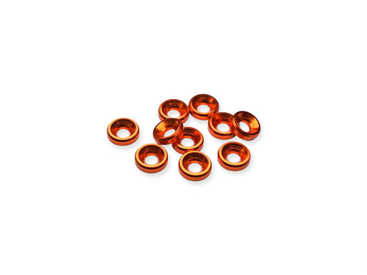 Close-up of 10 orange anodized aluminum countersink washers for M3 screws, arranged on a white background.