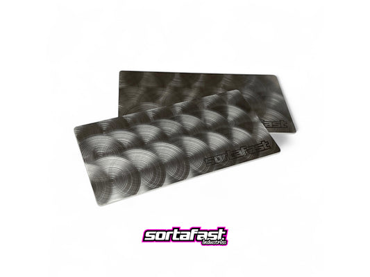 Two Sortafast stainless steel 1S/2S shorty battery weight plate with hand-applied engine-turned finish (38g).